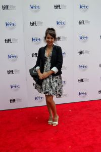 Poising on a red carpet sponsored by Veet