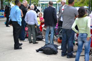 People at the front blocking the view of those behind by standing on platforms